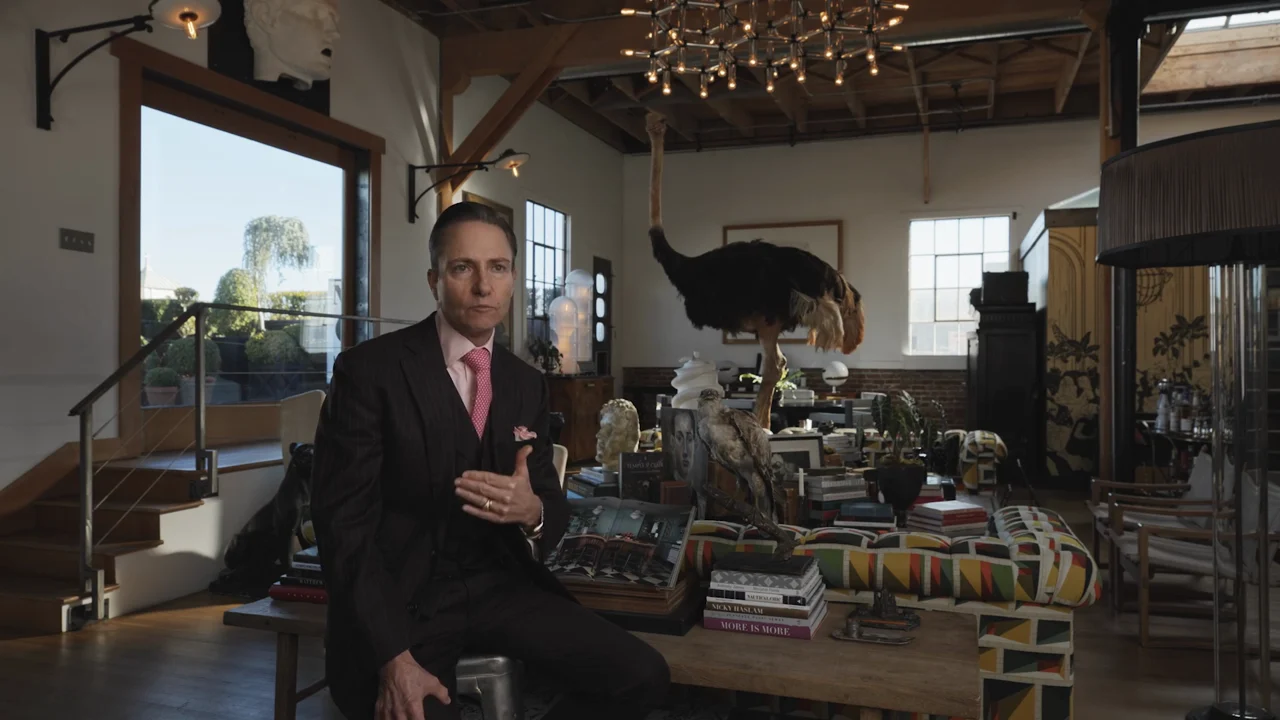 Designer Ken Fulk seated for an interview in his richly furnished studio