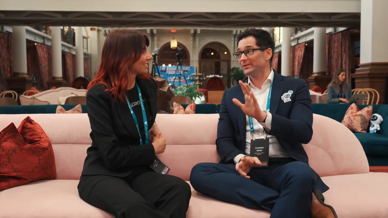 Two attendees in a filmed interview at the UserGems event